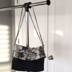 Leather tie-dye bag with black woven straw body.